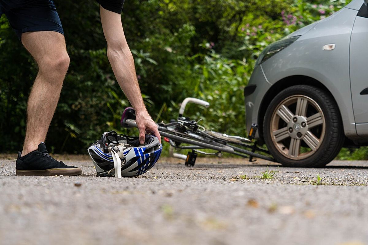 Miniature af Cyclist picks up helmet after bike accident